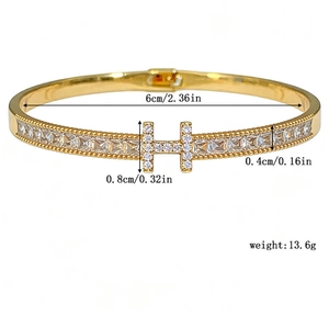 Detailed view of gold H-shaped buckle bracelet with micro-pave cubic zirconia crystals