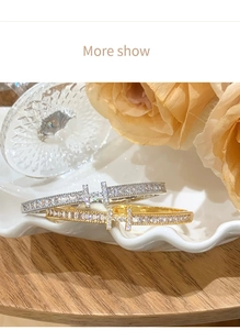 Top view of gold and silver luxury H-letter bangles with sparkling zircon micro-pave crystals