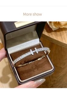 Close-up of silver H-shaped bangle with micro-pave zircons in a velvet jewelry box