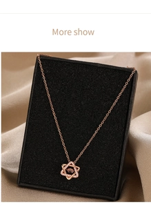 Detail of rose gold hexagram necklace with pavé cubic zirconia and a floating gem