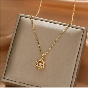 Macro shot of gold star necklace with dancing stone on a premium jewelry box display
