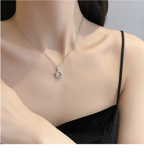 Close-up of sparkling hexagram pendant with dancing stone on a delicate silver chain