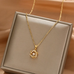 Elegant gold-plated hexagram necklace with sparkling zircon pendant on a luxury gift box