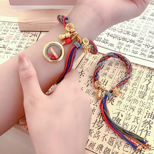 Handwoven Tibetan style colorful rope bracelet with gold Gawu box and tassel charms