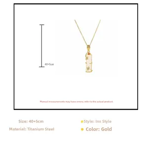 Detailed macro view of 18k gold-plated bamboo-shaped pendant with white faux jade texture