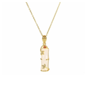 Detail of 18k gold plated bamboo necklace with white faux jade and red gemstone charm