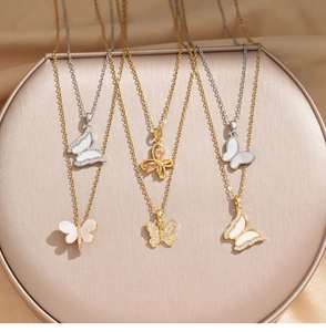 Detail view of titanium butterfly necklaces with sparkling zircon and shell inlay