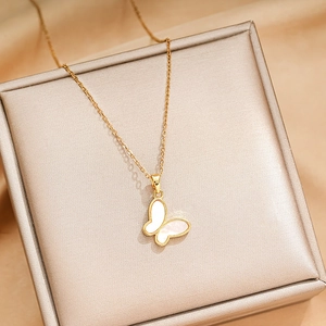 Elegant gold titanium steel butterfly pendant necklace with white shell on silk background