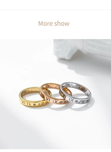 Detailed macro view of three titanium steel rings with Roman numerals and small diamonds