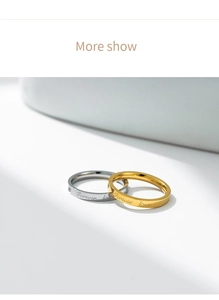 Detail view of gold and silver couple rings with Forever Love engraving on steel