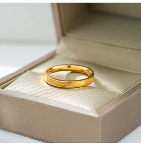 Detailed macro view of gold-plated ring engraved with Forever Love in a gift box