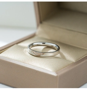 Detailed macro view of the silver Love ring with Forever Love engraving in a gift box