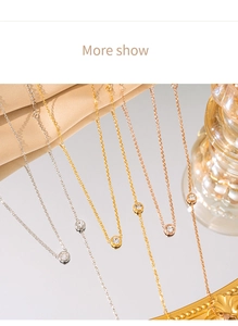 Detailed shot of gold, silver, and rose gold cubic zirconia necklaces on satin