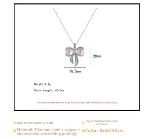 Detailed view of silver bow pendant with zircon inlays and dimensions on titanium necklace