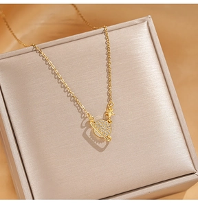 Close-up of golden Saturn pendant necklace with shimmering zircon stones and star detail