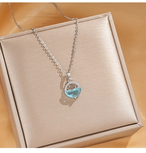 Close-up of cat eye stone planet pendant on champagne gold jewelry box display