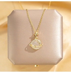 Macro shot of 18K gold planet necklace with opal stone and zircon on silk background