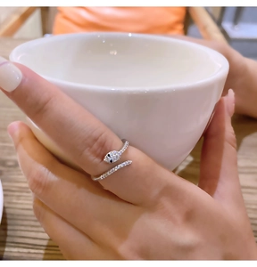 Macro detail of silver snake ring with sparkling cubic zirconia on a female hand