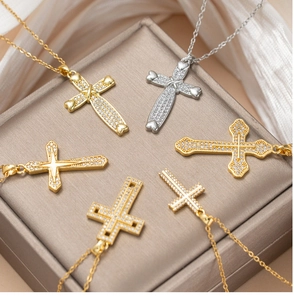 Detail of cross pendant necklaces in gold and silver finish with sparkling zircon stones
