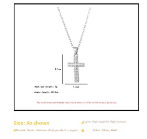 Macro detail of silver cross pendant with clear rhinestones on a titanium steel chain