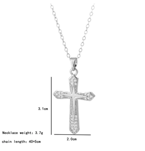 Macro detail of silver cross pendant with sparkling zircons and dimensions 3.1x2.0 cm