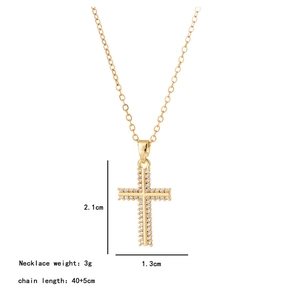 Detail view of crystal cross pendant with dimensions 2.1cm by 1.3cm on a gold chain
