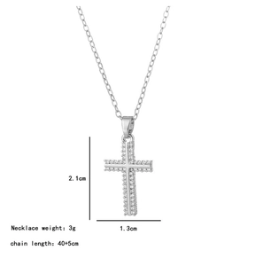 Detailed view of silver cross pendant with white zircon stones measuring 2.1cm by 1.3cm