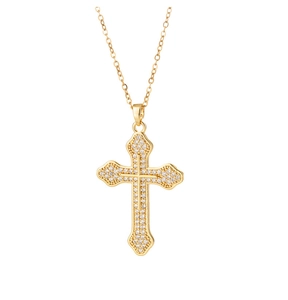 Close-up of a gold cross pendant necklace with sparkling pavé cubic zirconia inlay