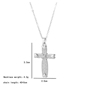 Detailed close-up of a high-quality silver cross pendant with sparkling crystals and heart ends