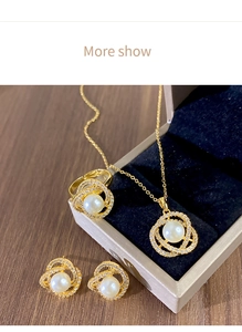 Détail d'un ensemble de bijoux en perles avec volutes dorées et zircons en boîte