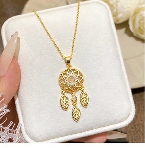 Detailed macro of golden dreamcatcher necklace with opal and zircon pendant details
