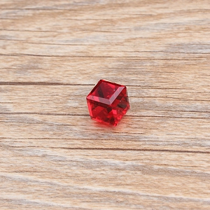 Macro shot of red cubic crystal charm with geometric facets for DIY jewelry making