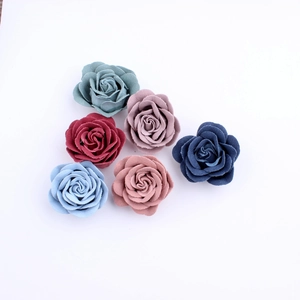 Macro view of handmade burnt edge fabric roses in six Morandi colors for DIY crafts