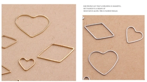 Detailed macro view of heart and rhombus shaped metal geometric charms for DIY jewelry making