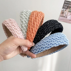 Detailed macro view showing five colors of braided mesh headbands with thick sponge core