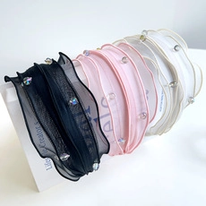 Detail of sheer organza scrunchies with elegant bead embellishments in classic colors