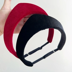 Detail view of thickened velvet headbands in black and red with elastic back straps