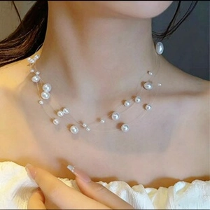 Detailed view of layered freshwater pearl necklace with floating effect on model neck