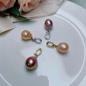 Detail of teardrop freshwater baroque pearl pendants in pink and orange shades