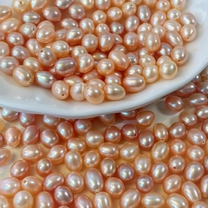 Macro detail of drop-shaped freshwater pearls in pink and purple for DIY jewelry making