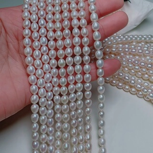 Detailed close-up of natural white freshwater pearl strands with glossy luster finish