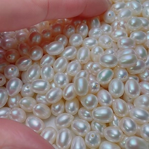 Macro detail of white freshwater rice pearls with pink and green iridescent luster