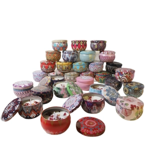 Scented soy wax candles with dried flowers in colorful bohemian tin jars set
