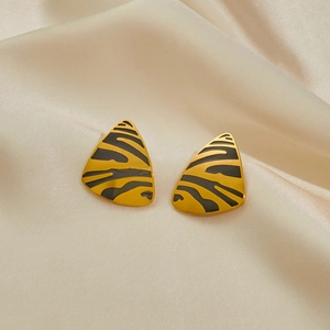 Elegant triangle leopard print stud earrings in 18K gold plated stainless steel on silk
