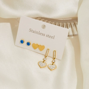 Detailed set of three stainless steel earrings featuring evil eye and heart charms