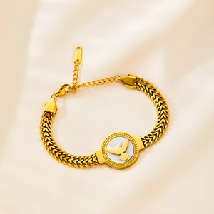 Luxurious gold stainless steel braided wheat bracelet with a white pearl bird charm