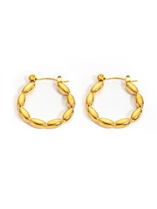 Macro detail of French vintage gold plated titanium steel hoop earrings with bead texture