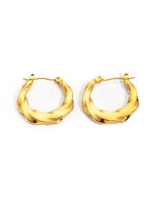 Detailed close-up of golden twist hoop earrings with elegant textured wave patterns