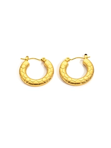 Close-up of golden stainless steel hoop earrings with textured snake scale pattern