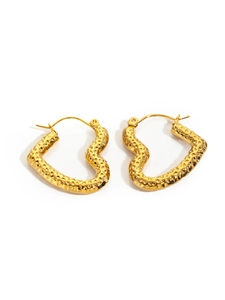 Detailed view of golden heart-shaped hoop earrings with unique hammered metal texture